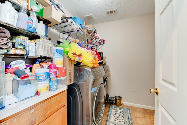 clothes washing area featuring light tile patterned floors, visible vents, laundry area, and baseboards