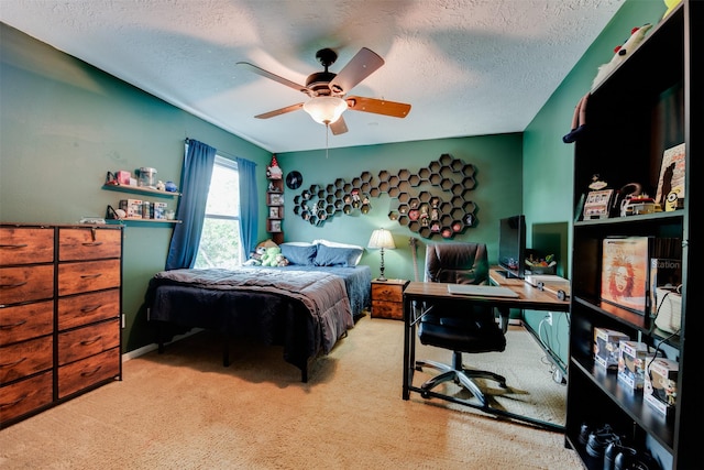 carpeted bedroom featuring a textured ceiling and ceiling fan
