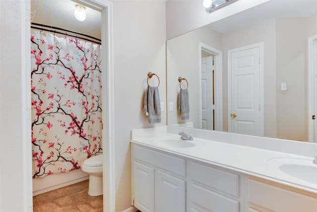 full bathroom with curtained shower, toilet, double vanity, and a sink
