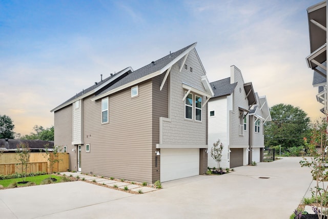 property exterior at dusk featuring a garage