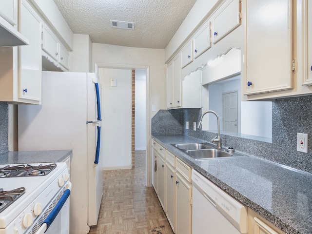 kitchen featuring white appliances, light parquet floors, sink, and white cabinets