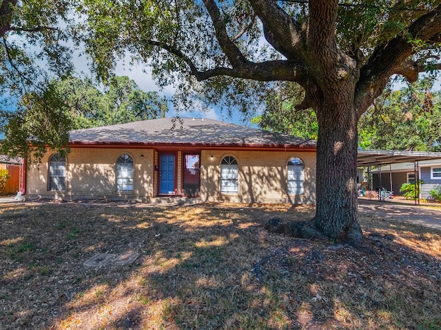 ranch-style house featuring a carport