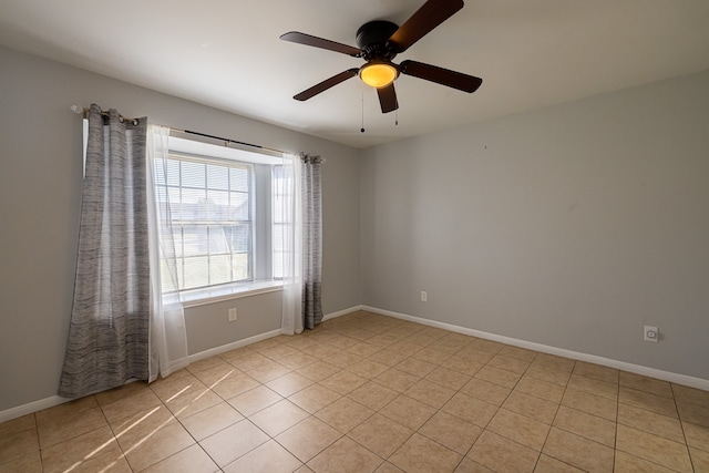 tiled spare room with ceiling fan