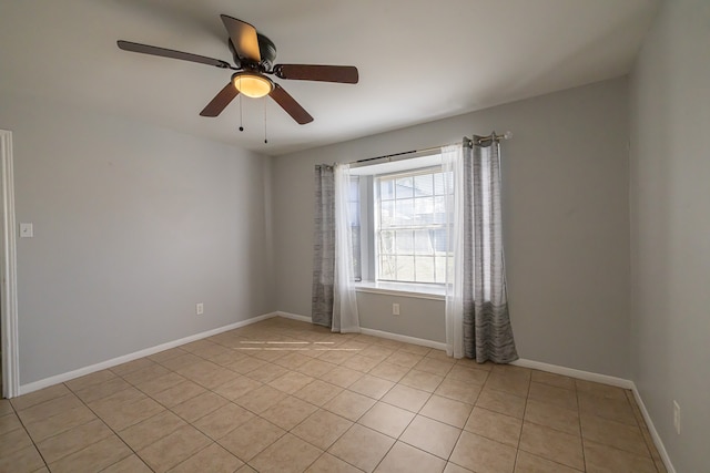 empty room with light tile patterned floors and ceiling fan