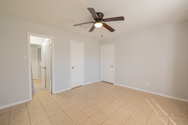 unfurnished bedroom with ceiling fan and light tile patterned floors