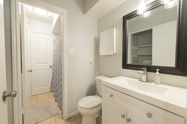 bathroom with vanity, toilet, and tile patterned floors