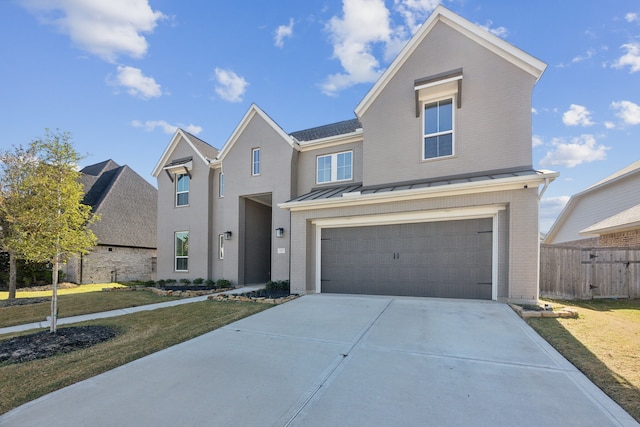 view of front of house featuring a front lawn and a garage