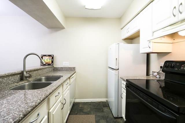 kitchen with white cabinetry, dark stone countertops, sink, and white appliances