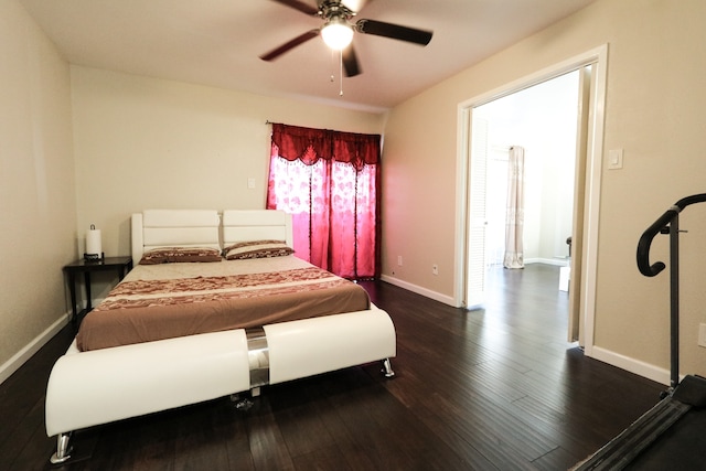 bedroom with dark hardwood / wood-style floors and ceiling fan