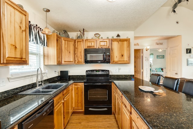 kitchen with sink, black appliances, pendant lighting, a textured ceiling, and light hardwood / wood-style floors