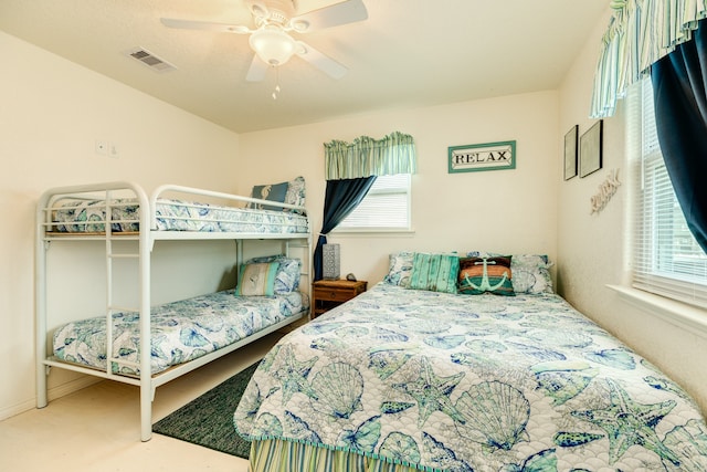 bedroom featuring multiple windows, carpet, and ceiling fan