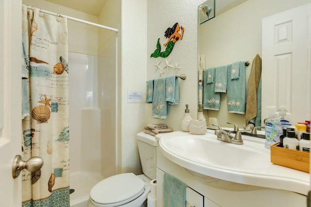 bathroom with vanity, toilet, and a shower with shower curtain