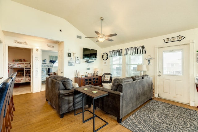 living room with light hardwood / wood-style floors, lofted ceiling, and ceiling fan