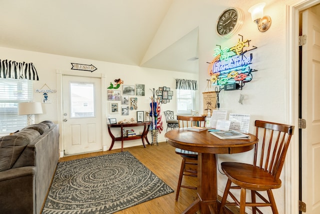 dining area with hardwood / wood-style flooring and lofted ceiling