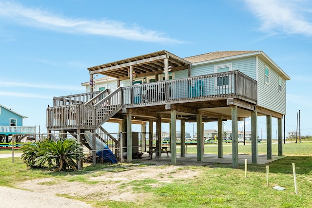 back of property with a wooden deck and a yard