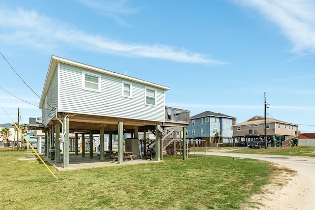 rear view of property featuring a yard