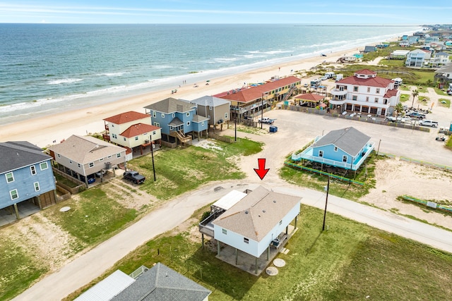 drone / aerial view with a water view and a beach view