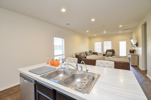 kitchen with dishwasher, sink, and dark wood-type flooring