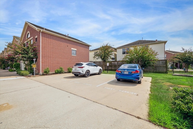 view of vehicle parking with a yard