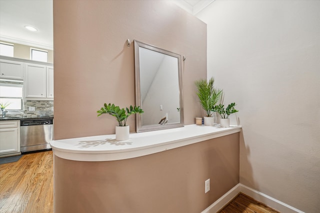 bathroom featuring wood-type flooring and backsplash