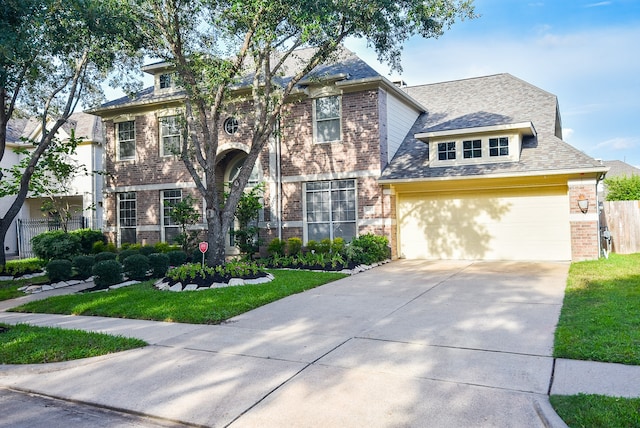 view of front facade featuring a front yard and a garage