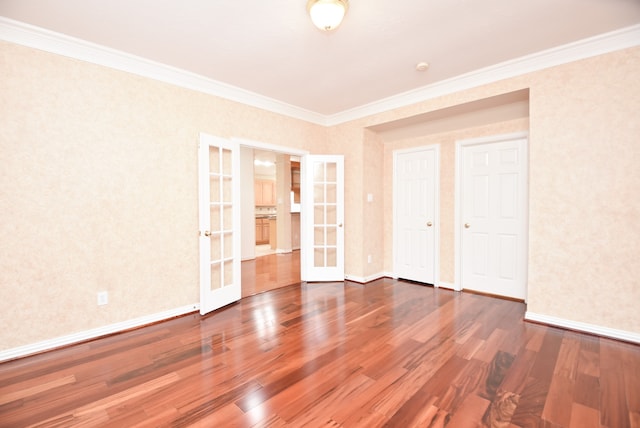 unfurnished bedroom featuring french doors, crown molding, and dark hardwood / wood-style flooring