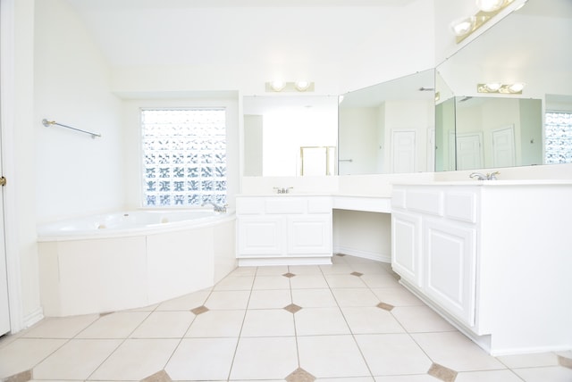 bathroom featuring a bathtub, tile patterned flooring, and vanity