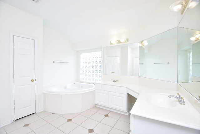 bathroom featuring vanity, vaulted ceiling, tile patterned floors, and a washtub