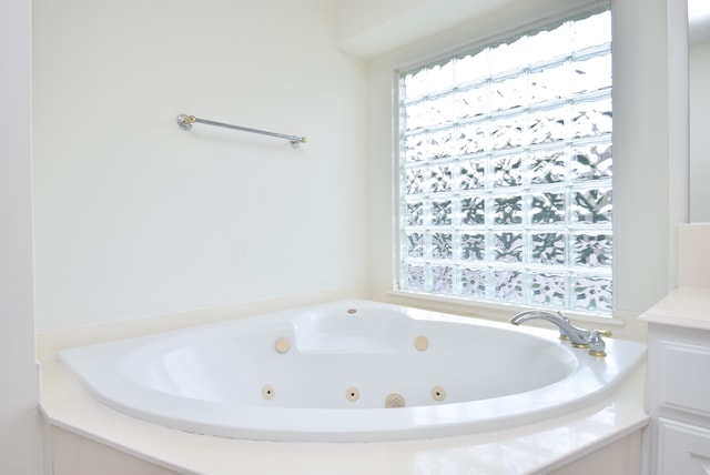 bathroom with a tub to relax in