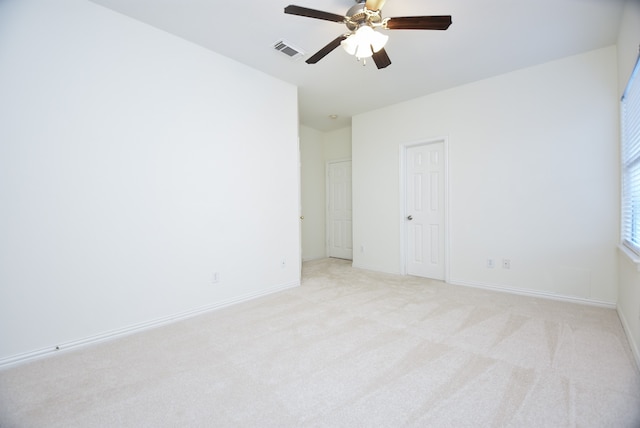 unfurnished room featuring light colored carpet and ceiling fan