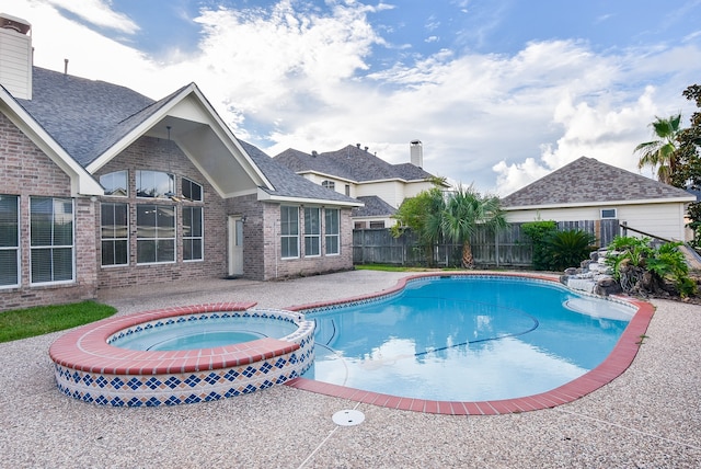 view of pool featuring an in ground hot tub and a patio