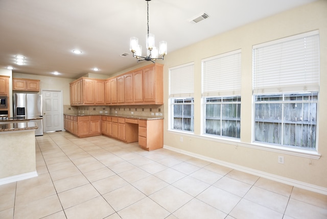 kitchen with tasteful backsplash, light tile patterned floors, stainless steel fridge with ice dispenser, a notable chandelier, and decorative light fixtures