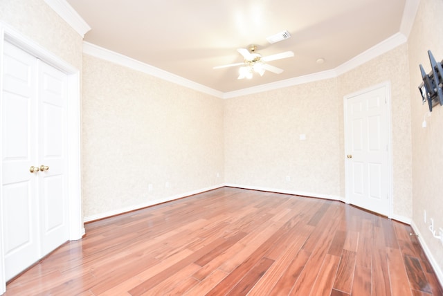 unfurnished room featuring crown molding, hardwood / wood-style flooring, and ceiling fan