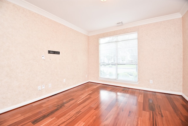 unfurnished room with hardwood / wood-style flooring and ornamental molding