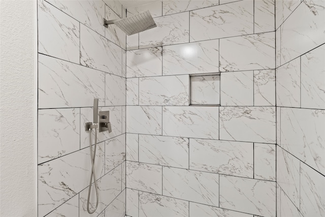 bathroom with tiled shower