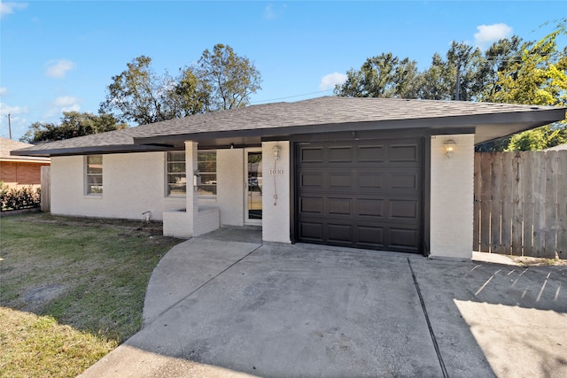 ranch-style house with a front yard and a garage