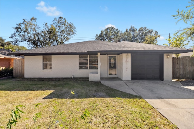 ranch-style home with a front yard and a garage