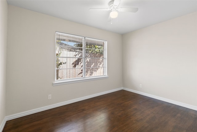 empty room with ceiling fan and dark hardwood / wood-style flooring