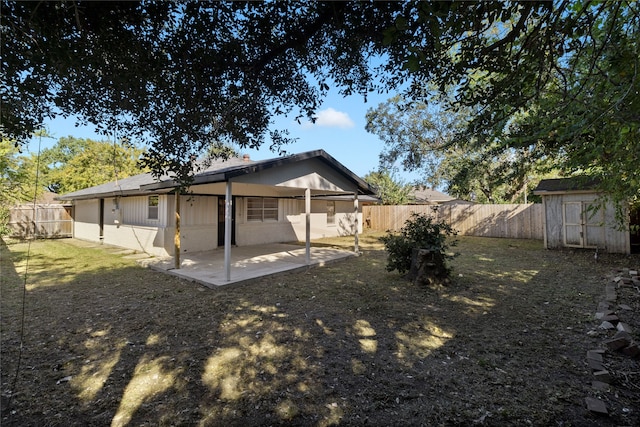 rear view of house featuring a patio and a shed