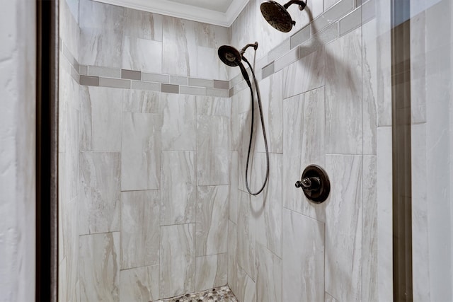 interior details with crown molding and tiled shower