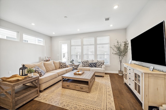 living room with dark hardwood / wood-style flooring and plenty of natural light