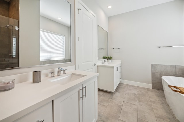 bathroom with tile patterned floors, vanity, and shower with separate bathtub