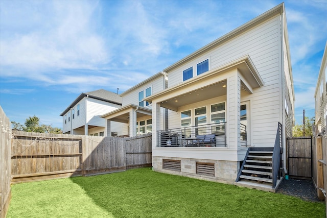 rear view of house with a yard