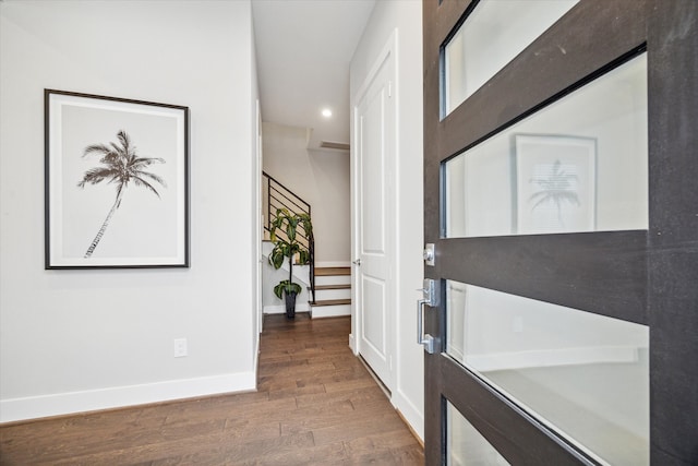 hallway with dark hardwood / wood-style flooring