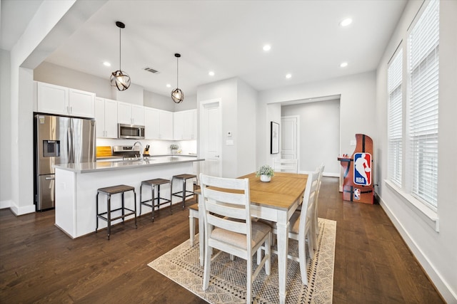 dining space featuring dark hardwood / wood-style flooring and sink