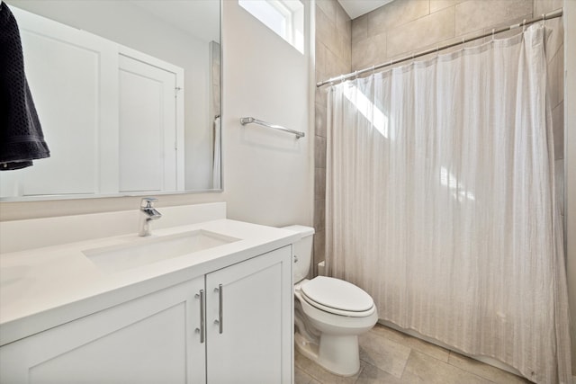 bathroom featuring toilet, a shower with curtain, vanity, and tile patterned floors