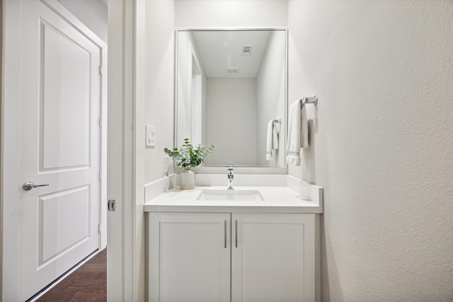 bathroom with hardwood / wood-style floors and vanity