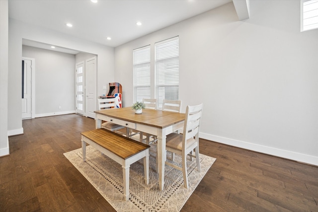 dining room with a healthy amount of sunlight and dark wood-type flooring