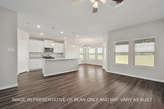 kitchen with a center island with sink, white cabinets, decorative light fixtures, dark hardwood / wood-style flooring, and stainless steel appliances