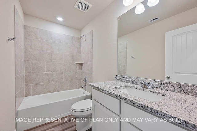 full bathroom with vanity, toilet, and tiled shower / bath